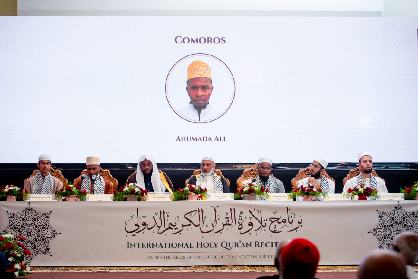 6 international qurraa sitting on stage